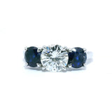 Round Brilliant Diamond & Blue Sapphire Three-Stone Engagement Ring