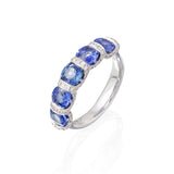 18kt white gold cushion shaped blue sapphie ring with 'u' style setting, pave diamonds. Sapphires have a combined total weight of 3.05cttw and diamonds have a combined total weight of 0.38cttw. G-H Color, SI Clarity.