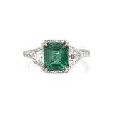 Emerald and diamond ring featuring a 1.61ct Colombian Emerald center stone with .38ct of Trapezoids (1 on either side) that are G color, VS clarity. There is .65ct of diamond pave throughout the ring. Made in 18k yellow gold and platinum. Size 6.5.