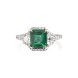 Emerald and diamond ring featuring a 1.61ct Colombian Emerald center stone with .38ct of Trapezoids (1 on either side) that are G color, VS clarity. There is .65ct of diamond pave throughout the ring. Made in 18k yellow gold and platinum. Size 6.5.