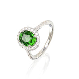 Lady's 14kt white gold oval chrome tourmaline ring with round white diamonds halo and round white diamonds down the half shank. All diamonds are set in a fishtail style prongs. Chrome tourmaline weighs approx 2.36cttw and the diamonds have a combined