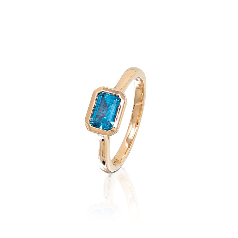 Rectangular Blue Ziron bezel set 7 x 5 mm faceted 14kt rose gold .08ct diamonds. 