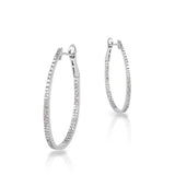 18kt white gold oval diamond hoop earrings. Earrings consist of 202 round pave diamonds weighing 0.77cttw and G-H color, SI Clarity.