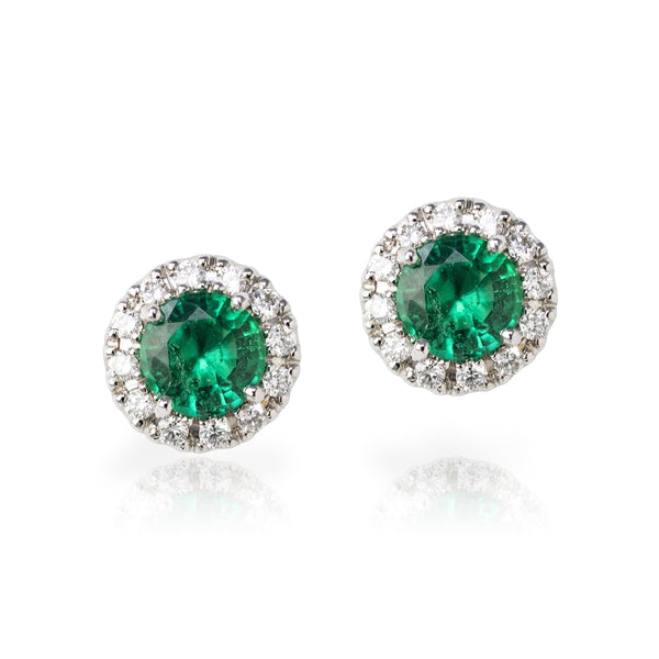 18kt white gold round emerald stud earrings with diamond halo. 1.35cttw of emeralds and 0.26cttw of diamonds in the halo. Diamonds are G-H,SI.