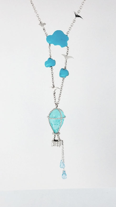 Mozambique-Paraiba 9.12 carat baloon shaped briollette facete gem, suspended by a hand made wire cable and basket in our basket ballon pendant. Hand crafted in platinum and added turquose couds and topaz weights. 