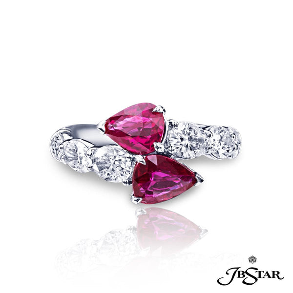 Spectacular and unique diamond and ruby ring featuring 2 exquisite No-Heat certified pear-shape rubies 2.35 ct. embraced by oval diamonds in a by ring design.