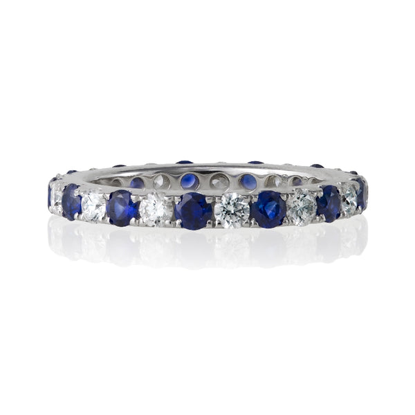 18kt white gold round diamond and round blue sapphire eternity band. Ring consists of 13 blue sapphires 0.86ctw and 13 round diamonds 0.61ctw. Diamonds are G-H Color, SI Clarity.