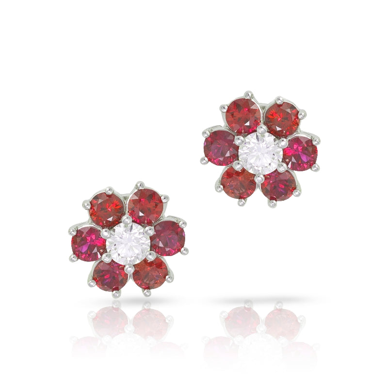 Burmese flower design earring with diamonds. Set with 6 round Burmese Rubies and one diamond in each earring, crafted in platinum. Diamonds weigh .53 and .52ct Rubies weigh 4.30cttw. 