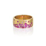 14kt rose gold cigar band ring. 8.7MM wide. Flush set pink sapphires and rubies, 1.16 total carat weight.