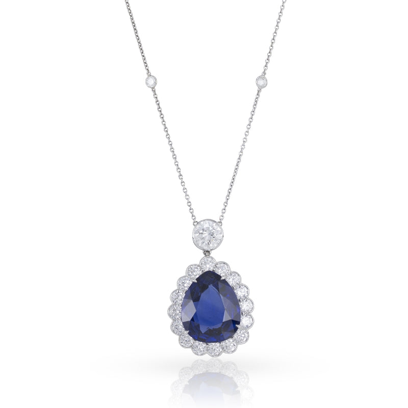 Pear-shape blue sapphire weighing 13.59ct, natural, from Sri Lanka set in a pendant with 2.25cts of E, VS round brilliant diamonds. A bezel-set 1.12ct, E, VVS2 round brilliant diamond tops the pendant. The pendant and diamond are connected to a diamo